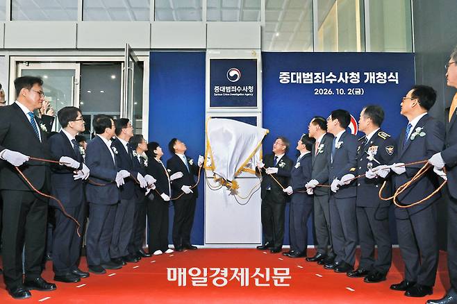 2일 서울 수표동 중대범죄수사청 본청 청사에서 열린 개청식에서 윤호중 행정안전부 장관(오른쪽 일곱번째)과 김영진 국회 행정안전위원장(왼쪽 일곱번째) 등이 현판 제막을 하고 있다. 중수청은 초대 청장이 공석인 데다 인력과 전산시스템, 청사 시설도 완비되지 않은 채 ‘개문발차’ 형태로 업무를 시작했다. [한주형 기자]