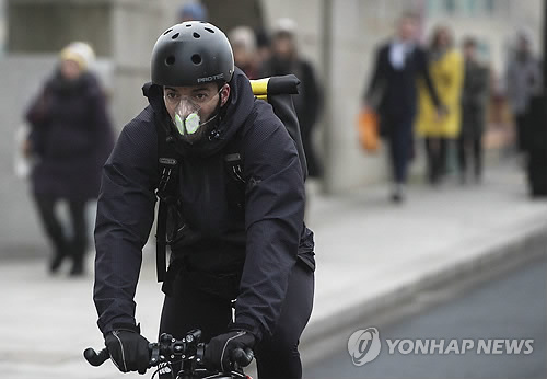 (런던 EPA=연합뉴스) 영국 런던의 대기오염이 중국 베이징보다 심한 가운데 한 자전거 이용자가 26일(현지시간) 마스크를 착용하고 있다.  2016475@yna.co.kr