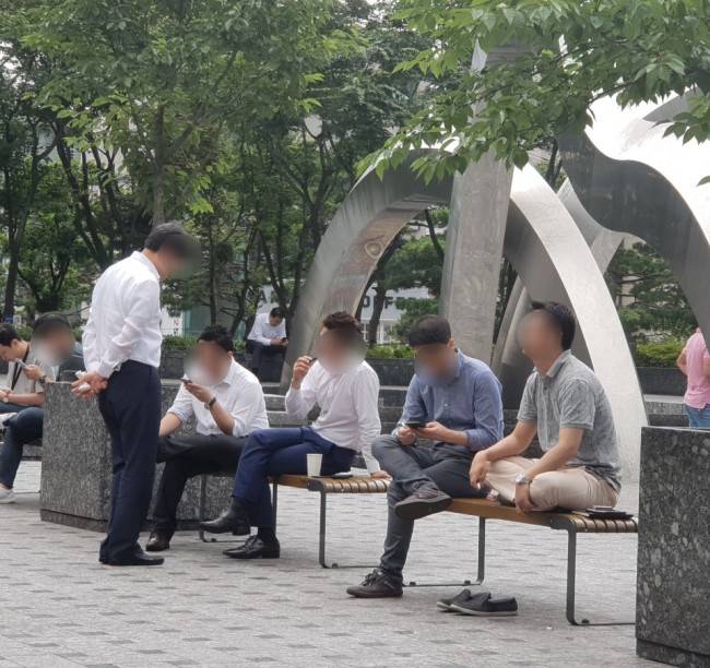 서울 강남구의 한 건물 앞에 마련된 흡연구역에서 담배 피는 사람들의 모습. 이현정 기자/rene@heraldcorp.com