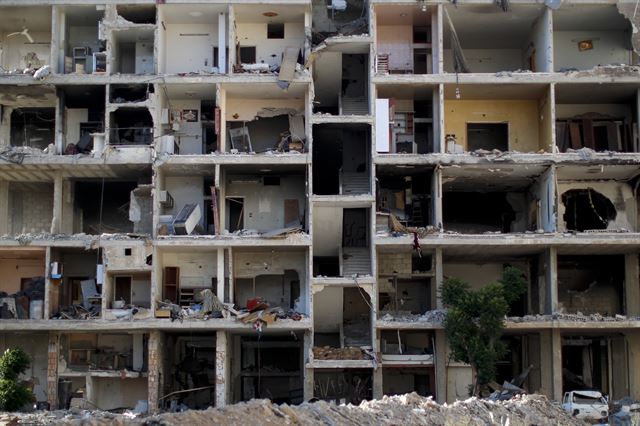 지난 16일(현지시간) 촬영한 사진으로 시리아 다마스쿠스의 야르무크 팔레스타인 난민캠프에서 벽면이 떨어져나간 건물의 내부 모습이 훤히 보이고 있다. 야르무크는 한때 팔레스타인 난민 16만 명과 시리아인들이 거주하는 지역이었으나 정부간 교전과 서로 다른 세력간의 싸움 속에서 주민들은 굶주림과 포위전술로 인한 극심한 고통을 겪었다. AP 연합뉴스