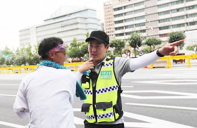 '대화경찰'이 차도로 내려와 이동하던 한 집회 참가자에게 통제구역에 대해 설명하고 있다. 김경록 기자