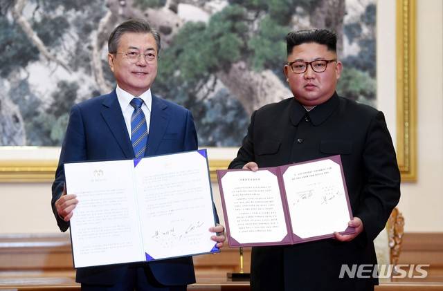 【평양=뉴시스】평양사진공동취재단 박진희 기자 = 문재인 대통령과 김정은 국무위원장이 19일 백화원 영빈관에서 정상회담을 마친 뒤 평양공동선언서에 서명한 뒤 펼쳐 보이고 있다. 2018.09.19. photo@newsis.com