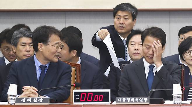 임종석 청와대 비서실장(오른쪽)이 6일 국회에서 열린 국회 운영위원회의 청와대에 대한 국정감사에서 장하성 정책실장과 대화하며 얼굴을 만지고 있다. 임현동 기자