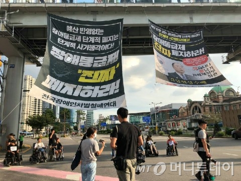 전국장애인차별철폐연대가 9일 오후 5시쯤 서울역 앞에서 장애등급제 폐지 등 시위를 벌이고 있다/사진제공=전국장애인차별처례연대