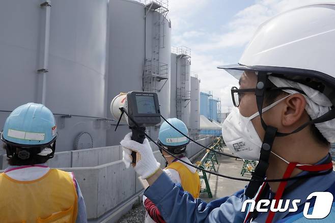 일본 도쿄전력 지원이 후쿠시마 제1원자력발전소 부지 내 방사성 오염수 저장탱크 주변애서 방사능 오염도를 측정하고 있는 모습. © AFP=뉴스1
