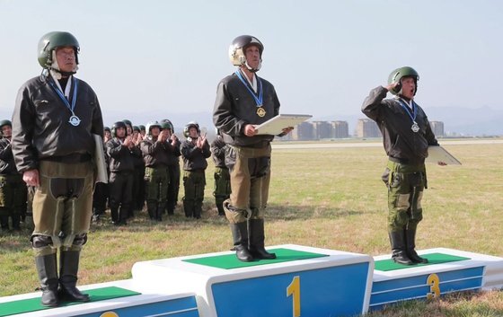 16일 북한 원산갈마비행장에서 열린 '조선인민군 항공 및 반항공군 비행지휘성원들의 전투비행술경기대회-2019'에서 뛰어난 실력을 보인 조종사들이 상장을 받고 있다.[연합뉴스]