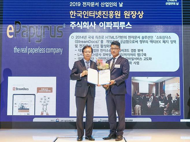 김정희 이파피루스 대표(오른쪽)가 김석환 한국인터넷진흥원장으로부터 13일 2019 전자문서 산업인의 날 유공포상을 받고 있다.