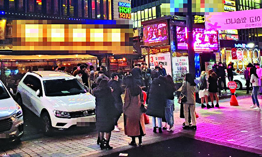 서울 강남의 한 헌팅포차에 14일 밤 젊은이들이 입장하기 위해 길게 줄을 서 있다. 코로나19 집단감염 우려로 많은 사람이 밀폐된 장소를 가기 꺼리지만 문을 연 일부 클럽이나 유흥업소는 여전히 불야성을 이루고 있다.
