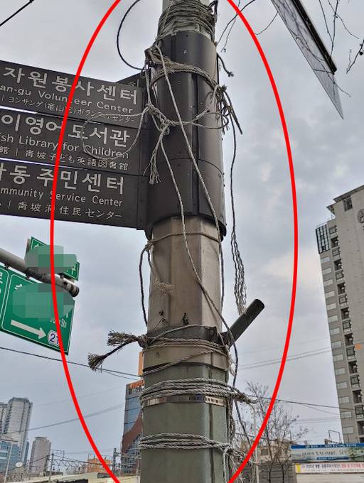 지난 21일 서울 용산구 한 횡단보도 인근 한 전신주에는 현수막만 제거된 채 묶었던 노끈은 그대로 남아 있다.