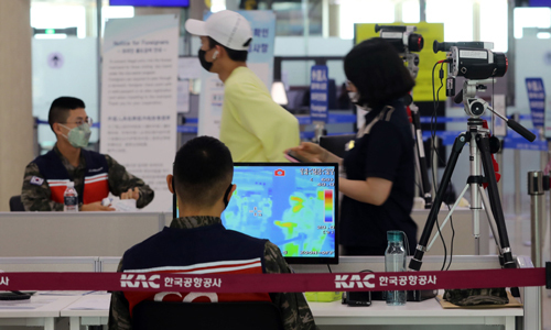 지난 24일 오후 제주국제공항 국내선 탑승장에서 관계자들이 열화상 카메라로 이용객들의 체온을 체크하고 있다. 뉴스1