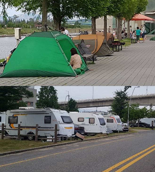 지난 12일 야영과 취사가 금지된 경인아라뱃길 수변에 시민들이 텐트를 치고 휴일을 즐기고 있다(위 사진). 도로 옆엔 캠핑카들이 주차돼 있다. 이 역시 불법이다.
