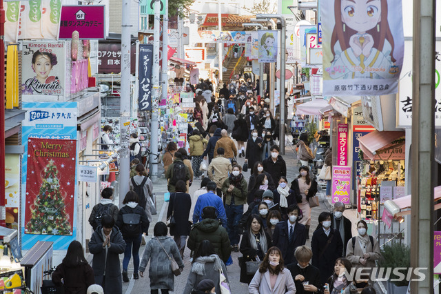 [도쿄=AP/뉴시스]17일 일본 도쿄 하라주쿠 부근의 유명 쇼핑 거리를 마스크를 쓴 사람들이 걷고 있다. 도쿄도는 이날 822명의 코로나19 신규 확진자가 확인됐다고 발표해 최다 일일 확진자 수를 이틀 연속 경신했으며 처음으로 일일 확진자 수가 800명을 넘었다. 2020.12.17.