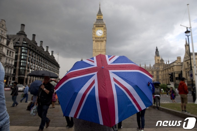 영국 런던의 웨스트민스터 궁전 북쪽 끝에 있는 시계탑과 영국 국기 모양 우산./사진=AFP/뉴스1