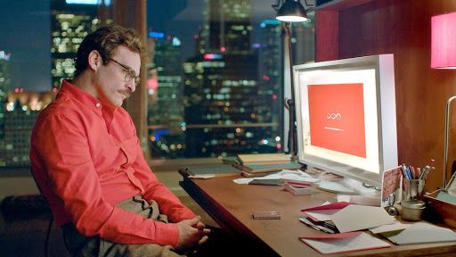 Theodore, played by actor Joaquin Phoenix, sets up the AI “Samantha” for his desktop computer in the movie “Her.” (Warner Bros. Pictures)