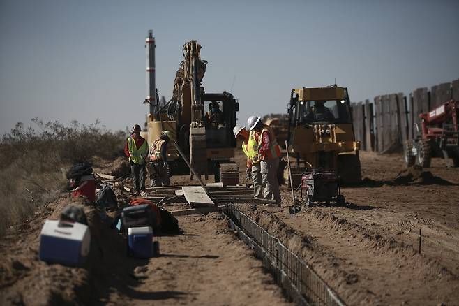 미국 뉴멕시코주 선랜드와 멕시코의 후아레즈 사이의 국경에서 12일 일꾼들이 우측 구 장벽을 대신할 국경장벽 기초공사를 하고 있다. AP =연합뉴스