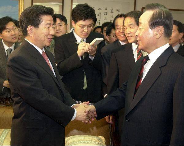 노무현(왼쪽) 당시 새천년민주당 대통령 후보가 2002년 4월 김영삼 전 대통령 자택을 찾아 악수하고 있다 /조선일보 DB