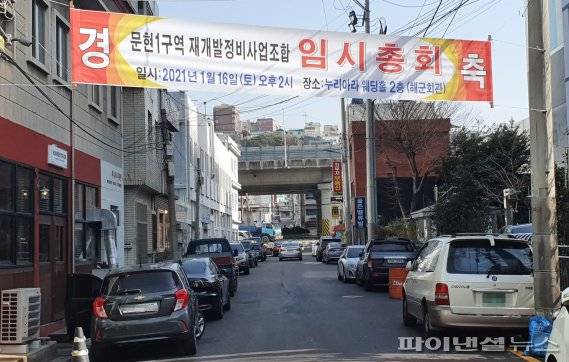 ▲ 공사비 1조가 넘는 부산 문현1 재개발사업지(남구 문현동 740-2 일대)에 임시총회 개최를 알리는 현수막이 걸려있다. 기자 촬영