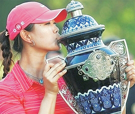 미셸 위가 2009년 11월 LPGA투어 로레나 오초아 인비테이셔널에서 우승한 뒤 트로피를 들며 활짝 웃고 있다.  LPGA투어 홈페이지