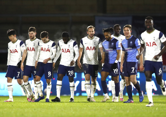 Tottenham Hotspur players react after Tanguy Ndombele, fourth from left, scored his side's third goal assisted by Son Heung-min, far left, against Wycombe Wanderers at Adams Park in High Wycombe, Britain, on Monday. [AP/YONHAP]