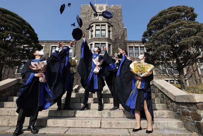 지난 22일 열린 2021년 연세대학교 학위수여식에서 졸업생들이 학사모를 던지며 기념사진을 찍고 있다. 사진=연합뉴스