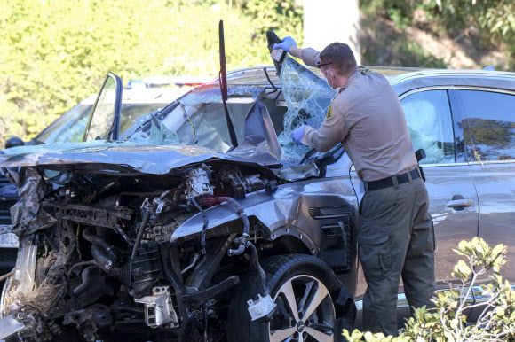 미 프로골퍼 타이거 우즈가 타고 있던 차량이 23일(현지시간) 미 캘리포니아주 로스앤젤레스 카운티 란초 팔로스 베르데스 인근에서 전복돼 한 경찰관이 사고 차량인 제네시스 GV80을 살펴보고 있다. AP=뉴시스