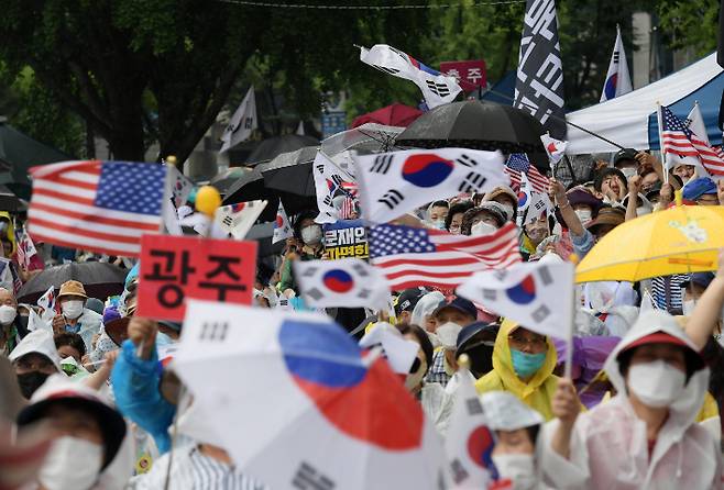 지난해 8월 15일 오후 서울 종로구 동화면세점 앞에서 열린 보수단체의 광복절 집회에서 참서자들이 태극기와 성조기를 흔들고 있다. 이한형 기자
