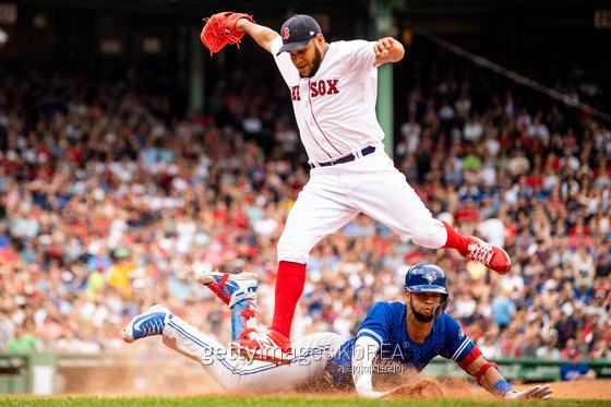 BOSTON, MA - JULY 14: Eduardo Rodriguez #57 of the Boston Red Sox collides with Lourdes Gurriel Jr. after covering first base and recording the out during the sixth inning of a game against the Toronto Blue Jays on July 14, 2018 at Fenway Park in Boston, Massachusetts. (Photo by Billie Weiss/Boston Red Sox/Getty Images)