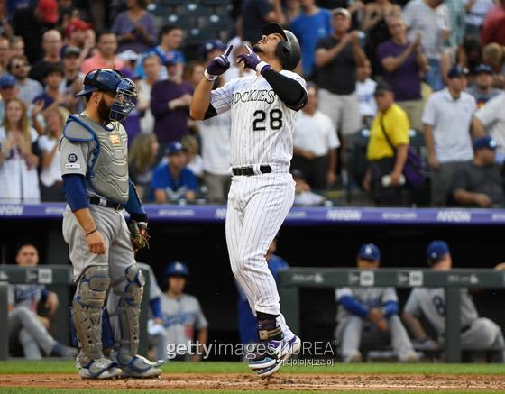 DENVER, CO - JUNE 28: Colorado Rockies third baseman Nolan Arenado (28) points to the sky after hitting a two-run home run against Los Angeles Dodgers starting pitcher Hyun-Jin Ryu (99) in the first inning scoring Charlie Blackmon at Coors Field June 28, 2019. Los Angeles Dodgers catcher Russell Martin (55) watches as Arenado crosses home plate. (Photo by Andy Cross/MediaNews Group/The Denver Post via Getty Images)
