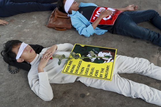반(反) 쿠데타 시위 초기이던 지난 2월 16일, 미얀마 최대 도시 양곤에서 시위대가 눈을 가리고 누워 군부에게 억압 당하는 미얀마 시민들의 모습을 연출하는 평화 시위를 벌이고 있다.[AP통신=연합뉴스]
