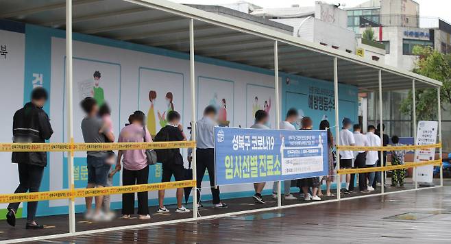 15일 서울 성북구 코로나19 임시 선별진료소에서 시민들이 검사를 대기하고 있다. 연합뉴스