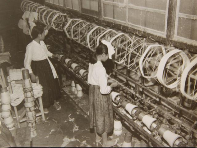 1951년 9월 9일 부산의 한 면사 공장에서 소녀들이 티셔츠를 만들기 위해 목화에서 실을 뽑아내고 있는 모습. 미국 국립문서기록관리청(NARA) 제공