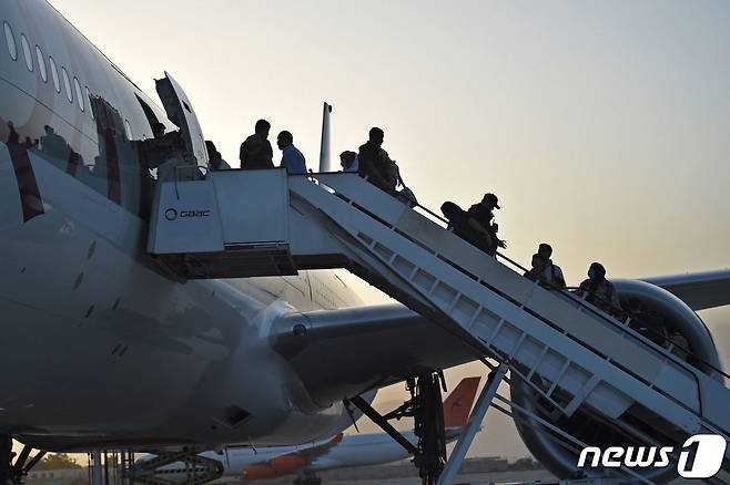 미국인 등 승객 200명이 9일(현지시간) 아프가니스탄 카불 공항에서 카타르 항공 소속 여객기에 오르고 있다. 지난달 30일 밤 11시59분 마지막 미 군 수송기가 떠난 이후 첫 탈출 비행이다 © AFP=뉴스1 © News1 안은나 기자