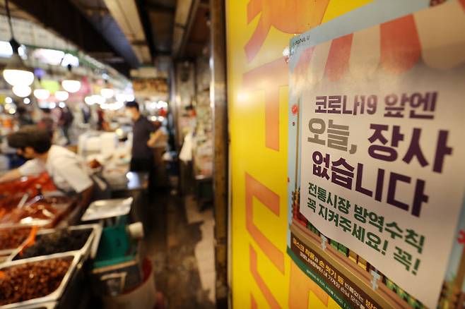 코로나19 확산세가 이어지고 있는 가운데 13일 오후 서울 종로구의 한 전통시장에 방역 관련 안내문이 붙어 있다. (사진=연합뉴스)
