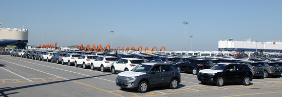 SsangYong Motor's Korando e-Motions wait to be loaded onto a ship headed overseas at a port in Pyeongtaek, Gyeonggi, on Thursday. The Korean automaker held a ceremony celebrating the first export of its first fully electric version of its popular SUV model. [SSANGYONG MOTOR]