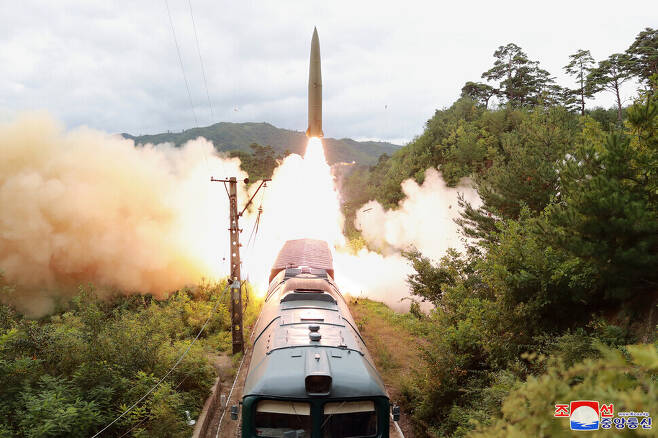 The Rodong Sinmun reported on their first page that “a rail-launched missile regiment operating in a mountainous region in central North Korea [. . .] accurately hit its target on the water 800 kilometers away in the Eastern Sea.” The missile, inferred to be a North Korean enhanced Iskander short-range ballistic missile, is seen here being launched from a train. (KCNA/Yonhap News)