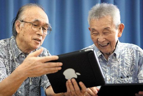 일본 도쿄의 컴퓨터 동호회에서 오카다 도시히로씨와 엔주지 마사토씨가 태블릿PC를 사용하며 즐거워하고 있다. /연합뉴스