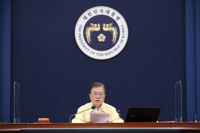 Citing economic damages from pandemic control measures, President Moon Jae-in said Korea could "no longer put off returning to normal in phases" during a Cabinet meeting Tuesday. (Yonhap)