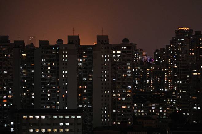 중국이 최근 심각한 전력난을 겪고 있는 가운데 27일 밤 최대 경제 도시 상하이의 주거용 빌딩들이 불을 밝히고 있다. 중국 국가전력망공사 상하이지사는 이날부터 10월 3일까지 '특정 시기, 특정 지역'에서 정전을 한다고 이날 공지했다.
