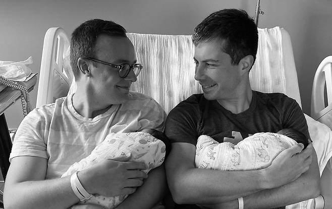 피터 부티지지 미국 교통장관(오른쪽)은 지난 9월 트위터에 배우자 글래즈먼(왼쪽)과 입양한 두 아이를 한 명씩 안은 채 마주보며 웃는 사진을 공개했다./피터 부티지지 트위터