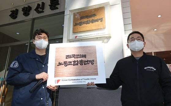 20일 오후 신전국대학생대표자협의회, 자영업연대 관계자들이 민주노총의 총파업 강행을 규탄하며 서울 중구 정동 민주노총 사무실 현판 앞에 '전국민폐노동조합총연맹'이라고 적힌 현판을 거는 퍼포먼스를 하고 있다. 연합뉴스