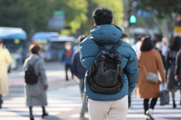 아침 기온이 5도까지 내려가 쌀쌀한 날씨를 보인 이달 20일 오전 서울 종로구 광화문네거리에서 두꺼운 외투를 입은 시민들이 발걸음을 옮기고 있다. [사진 출처 = 연합뉴스]
