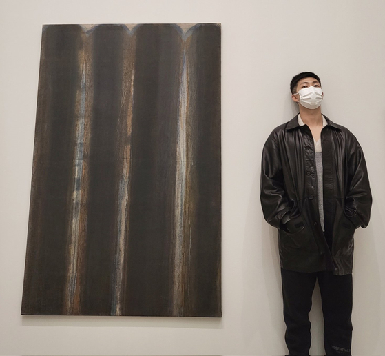 RM stands beside a painting by artist Yun Hyong-keun at PKM Gallery. [BTS OFFICIAL TWITTER]