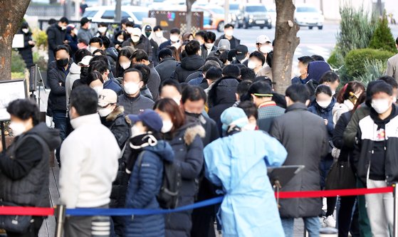 25일 오전 서울 송파구보건소 선별진료소에서 시민들이 코로나19 검사를 받기 위해 길게 줄 서 있다. 뉴시스
