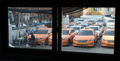 코로나19 바이러스 확산 여파로 법인택시 운전자 수가 급감한 가운데 지난해 11월 서울 시내 한 택시업체 차고지에 운전사를 구하지 못해 운행하지 못하는 택시들이 주차되어 있다. 서울 법인택시 기사는 2019년 말 3만527명에서 올해 10월 2만955명으로 30.4% 급감했다. 연합뉴스
