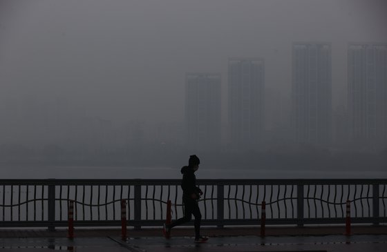 짙은 안개와 미세먼지가 찾아온 지난해 1월 22일 한 시민이 서울 잠수교에서 달리기를 하고 있다. 연합뉴스