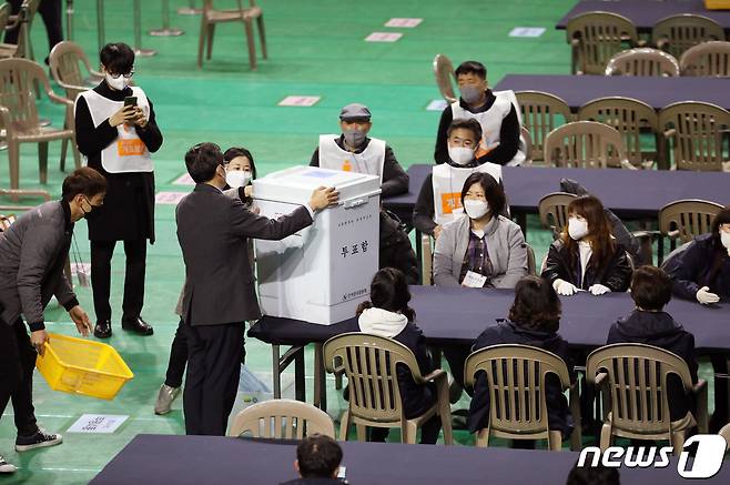 인천선관위관계자들이 10일 인천 삼산체육관에서 유튜브 채널 '가로세로 연구소(가세연)' 와 일부 인천 시민들이 이동을 못하도록 막은 투표함을 개표하기 전 투표함을 살펴보고 있다.2022.3.10/뉴스1 © News1 정진욱 기자