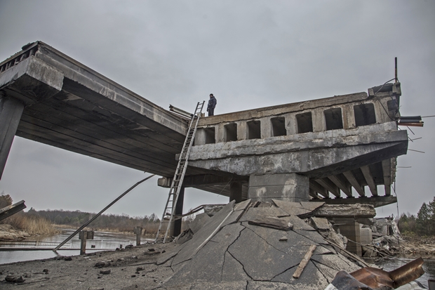 5일(현지시간) 우크라이나군이 러시아군 포격으로 파괴된 체르노빌과 근처 마을 사이 다리 위에 서 있다./AP 연합뉴스