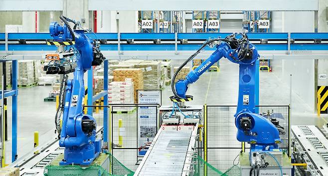 CJ대한통운이 개발한 물류 기술이 연이어 특허 등록에 성공했다. 사진은 CJ대한통운 동탄 풀필먼트센터에서 ‘AI 로봇 디팔레타이저’가 박스를 컨베이어벨트로 옮기는 모습. /사진=CJ대한통운