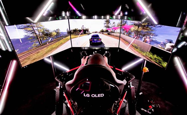 This photo shows a gamer with LG Electronics' gaming OLED TVs that use OLED panels by LG Display. (LG Electronics)