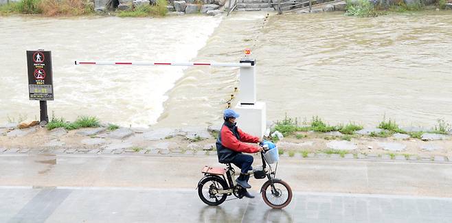 지난 24일 전북 전주시 전주천이 밤사이 내린 빗물에 불어 넘실대고 있다.   뉴시스